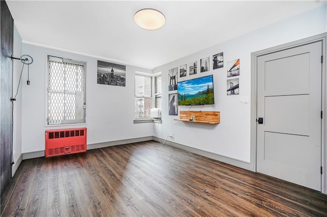 9707 4th Ave Unit 4P, Brooklyn, NY 11209 - unfurnished room with radiator heating unit, healthy amount of natural light, and wood finished floors