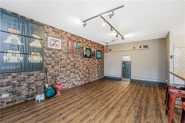 9707 4th Ave Unit 4P, Brooklyn, NY 11209 - empty room with brick wall and wood finished floors
