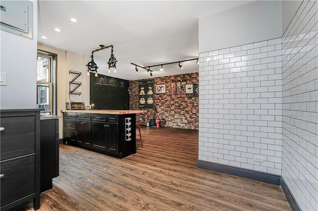9707 4th Ave Unit 4P, Brooklyn, NY 11209 - bar area with wood finished floors, brick wall, and recessed lighting