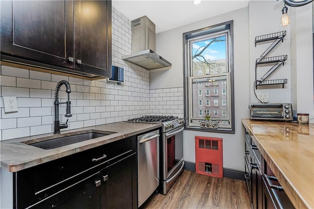 9707 4th Ave Unit 4P, Brooklyn, NY 11209 - kitchen with wall chimney range hood, appliances with stainless steel finishes, wooden counters, dark wood-style flooring, and backsplash