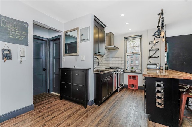 9707 4th Ave Unit 4P, Brooklyn, NY 11209 - kitchen with wall chimney exhaust hood, stainless steel range with gas cooktop, dark wood-style flooring, tasteful backsplash, and wooden counters