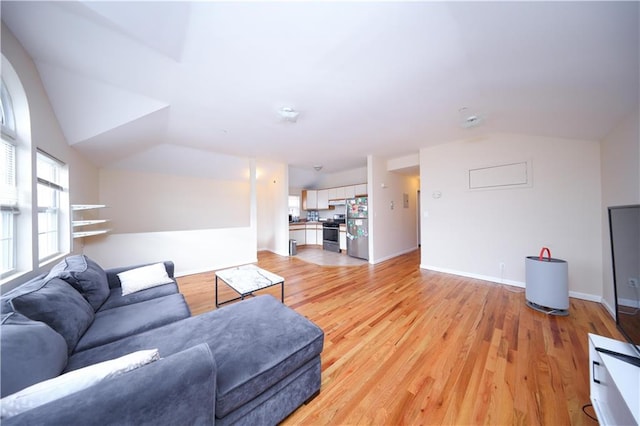 living area featuring light wood-style flooring and baseboards