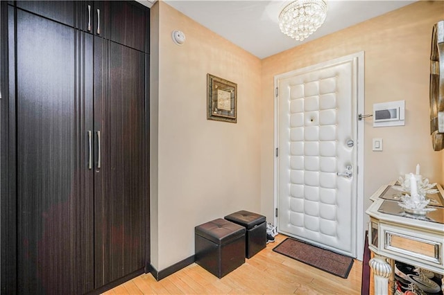 45 Oceana Dr E Unit 4B, Brooklyn, NY 11235 - foyer with light wood-style flooring, a chandelier, and baseboards