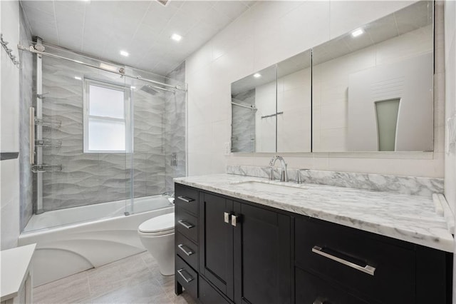 bathroom with toilet, recessed lighting, shower / bath combination with glass door, and vanity