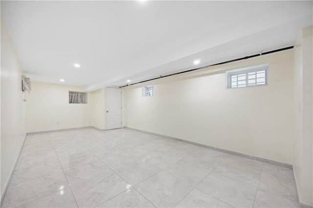 below grade area featuring baseboards, recessed lighting, and a wealth of natural light