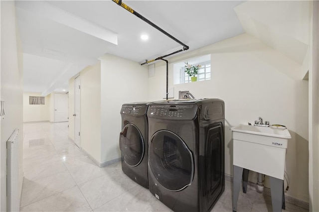 laundry area featuring baseboards and washer and clothes dryer