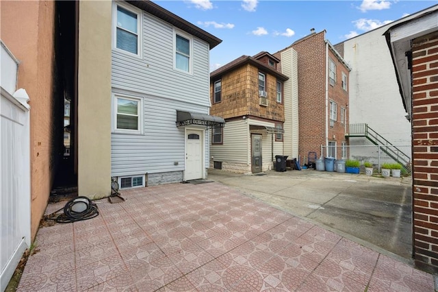 rear view of house featuring a patio area and fence