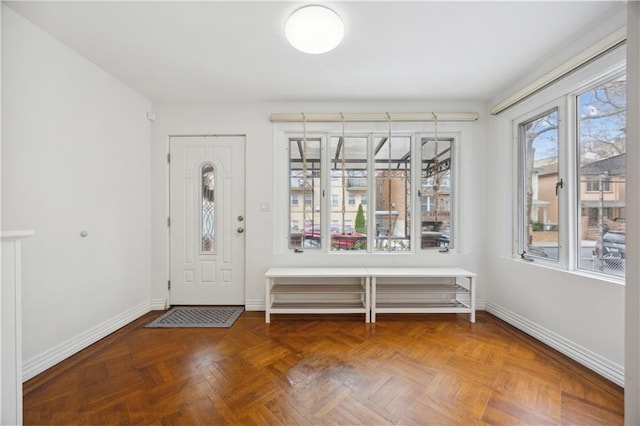 foyer featuring baseboards