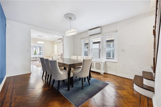dining room featuring baseboards and a wall mounted air conditioner