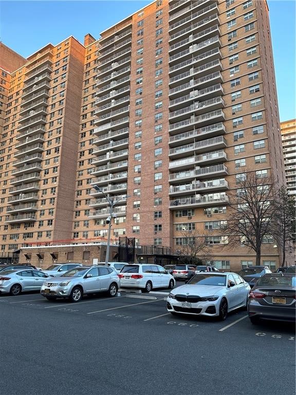 view of building exterior with uncovered parking