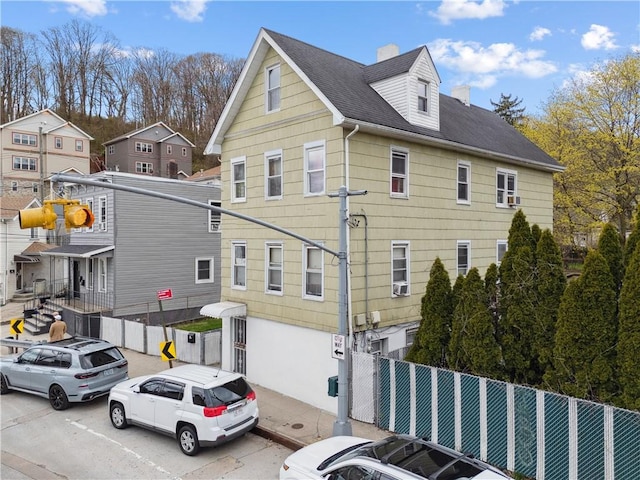 980 Van Duzer St, Staten Island, NY 10304 - exterior space featuring fence, a chimney, and roof with shingles