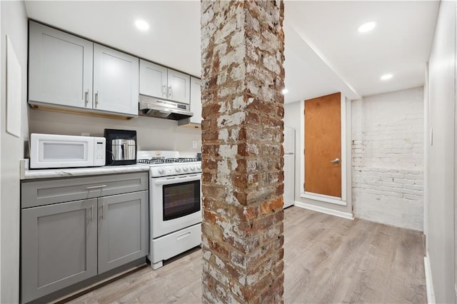 980 Van Duzer St, Staten Island, NY 10304 - kitchen featuring light wood finished floors, white appliances, gray cabinets, light countertops, and under cabinet range hood