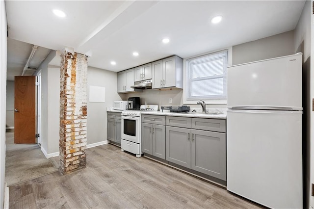 980 Van Duzer St, Staten Island, NY 10304 - kitchen with a sink, white appliances, light wood-style flooring, under cabinet range hood, and gray cabinetry
