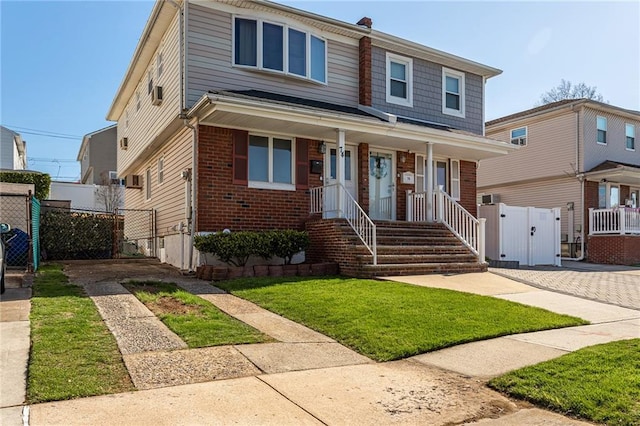 74 E Brandis Ave, Staten Island, NY 10308 - view of front of house featuring brick siding, a gate, a porch, and driveway
