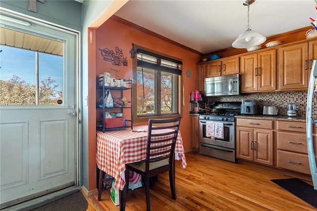 74 E Brandis Ave, Staten Island, NY 10308 - kitchen with stainless steel appliances, plenty of natural light, crown molding, decorative backsplash, and brown cabinetry