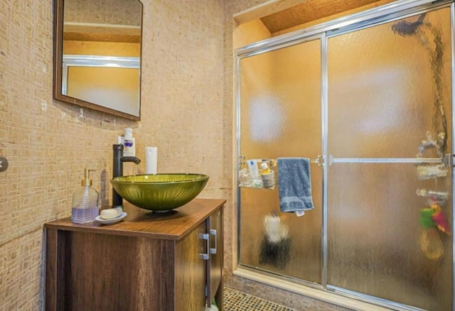 bathroom with a shower stall, tile patterned flooring, and vanity