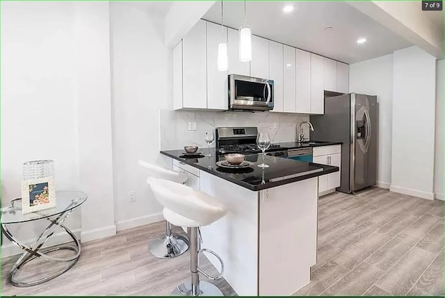 2503 Ocean Ave Unit 3B, Brooklyn, NY 11229 - kitchen with stainless steel appliances, light wood finished floors, dark countertops, baseboards, and recessed lighting