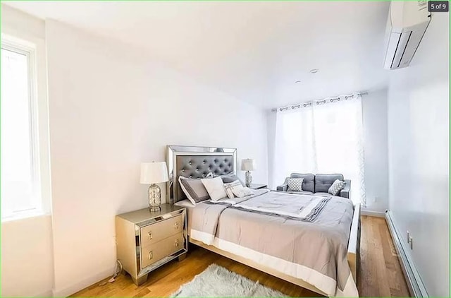 2503 Ocean Ave Unit 3B, Brooklyn, NY 11229 - bedroom featuring a wall unit AC, wood finished floors, and a baseboard heating unit