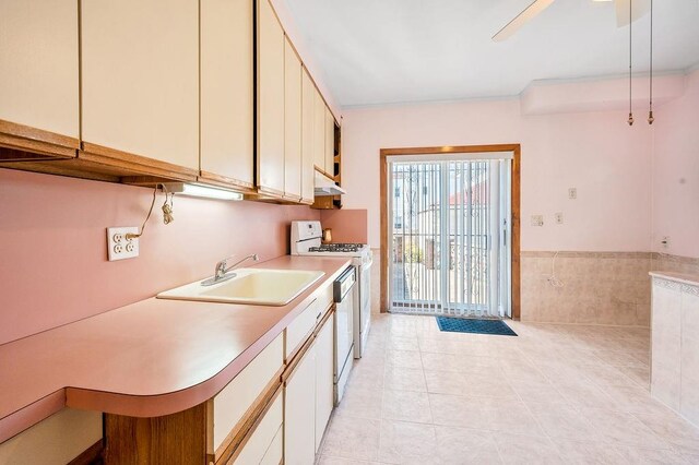 1142 78th St, Brooklyn, NY 11228 - kitchen featuring a sink, white appliances, light countertops, under cabinet range hood, and light tile patterned floors