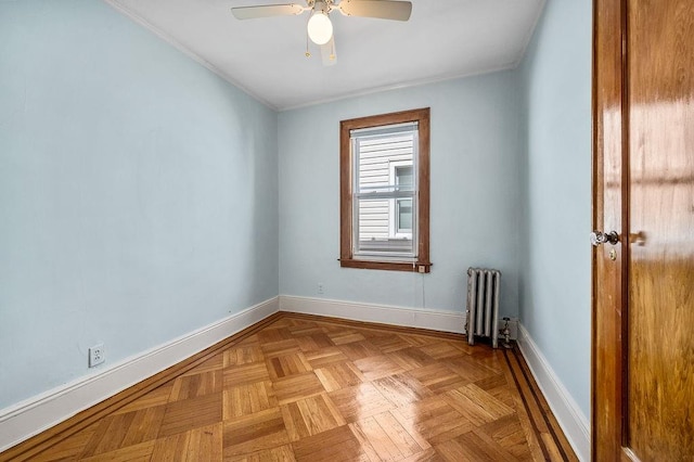 unfurnished room with radiator, a ceiling fan, baseboards, and crown molding