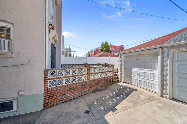 view of home's exterior featuring fence, driveway, and stucco siding