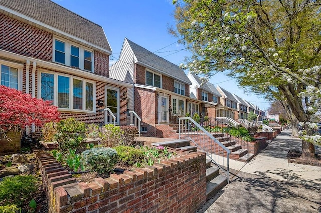 view of front of property featuring brick siding and a residential view