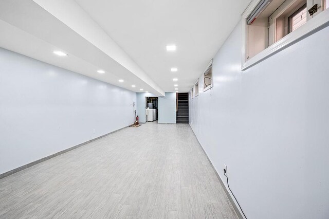 finished basement featuring stairway, recessed lighting, light wood finished floors, and baseboards