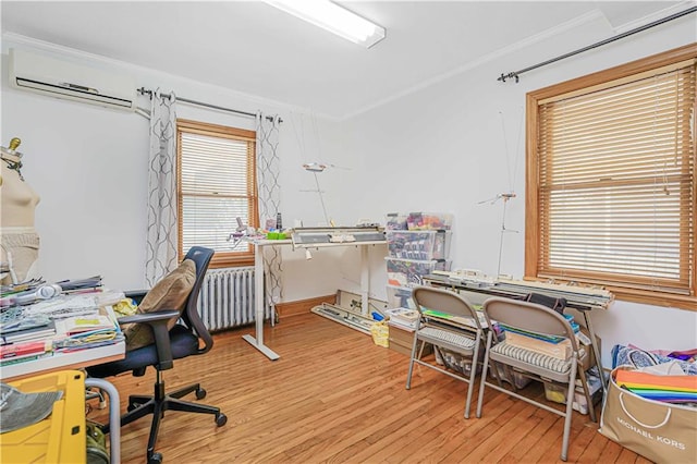 home office featuring crown molding, radiator heating unit, wood finished floors, and an AC wall unit
