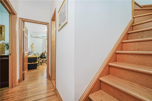 staircase featuring wood finished floors