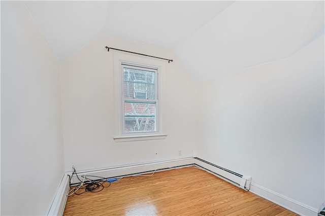 bonus room with lofted ceiling, wood finished floors, baseboards, and baseboard heating