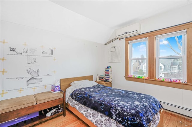 bedroom featuring a wall mounted AC, a baseboard heating unit, wood finished floors, and lofted ceiling