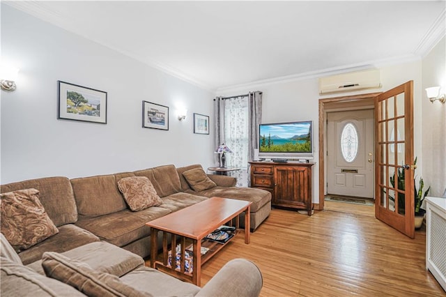 living area featuring an AC wall unit, ornamental molding, and light wood-style floors