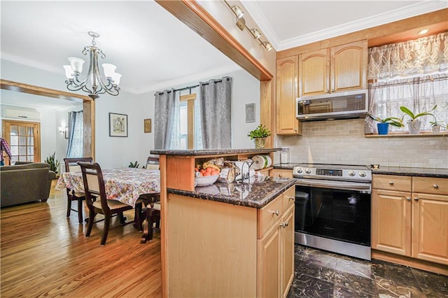 kitchen with appliances with stainless steel finishes, tasteful backsplash, light brown cabinetry, a chandelier, and dark stone counters