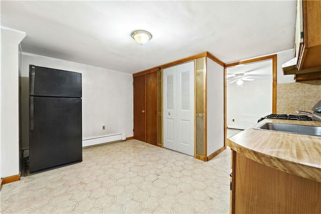 2554 W 16th St, Brooklyn, NY 11214 - kitchen featuring freestanding refrigerator, a baseboard heating unit, ceiling fan, and light floors