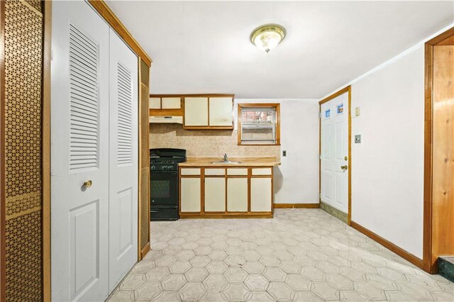2554 W 16th St, Brooklyn, NY 11214 - kitchen with gas stove, light countertops, and under cabinet range hood