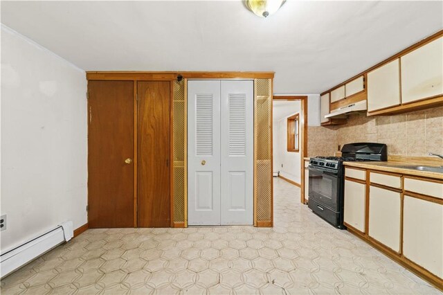 2554 W 16th St, Brooklyn, NY 11214 - kitchen with black gas range, baseboard heating, under cabinet range hood, light flooring, and light countertops