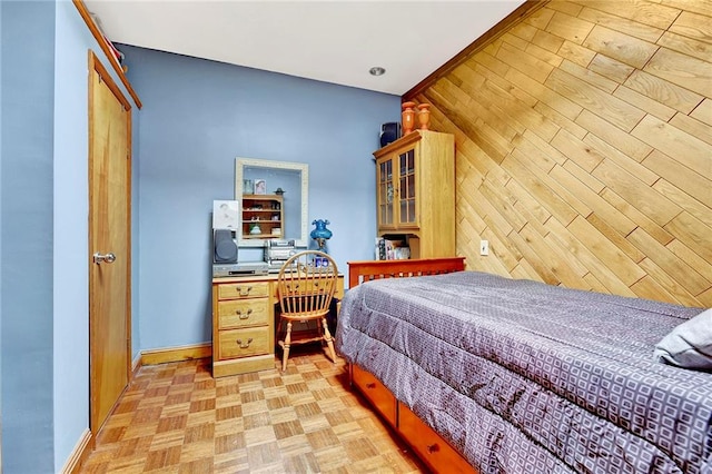 bedroom featuring baseboards and an office area