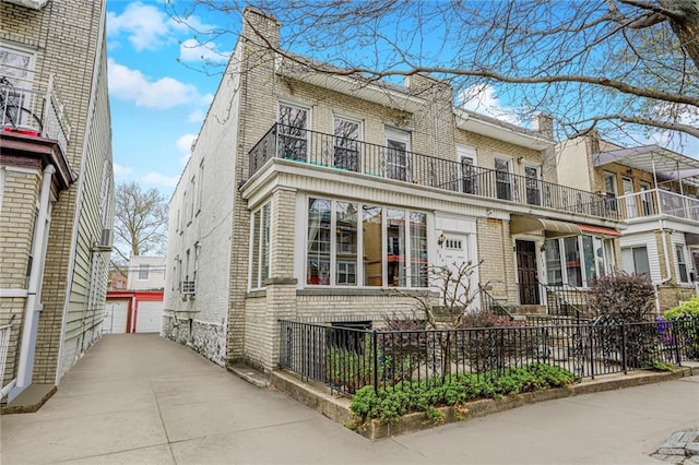 334 83rd St, Brooklyn, NY 11209 - townhome / multi-family property with brick siding, a chimney, an outdoor structure, and a garage