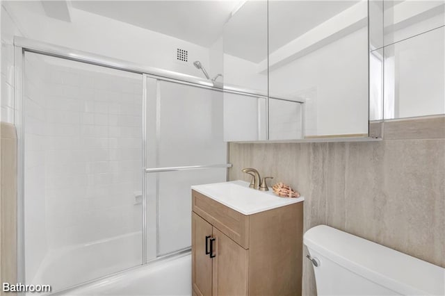35 Seacoast Ter Unit 16D, Brooklyn, NY 11235 - bathroom featuring toilet, vanity, and enclosed tub / shower combo