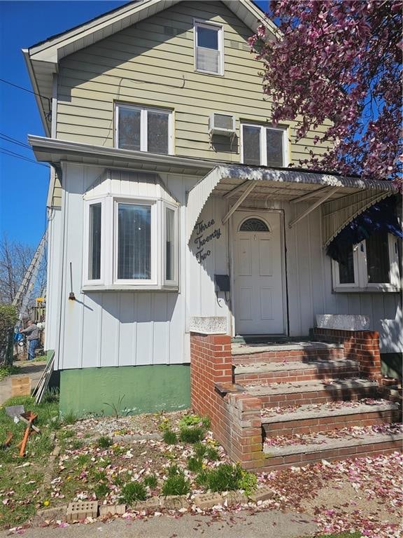 322 Morningstar Rd, Staten Island, NY 10303 - view of front of home with board and batten siding and an AC wall unit