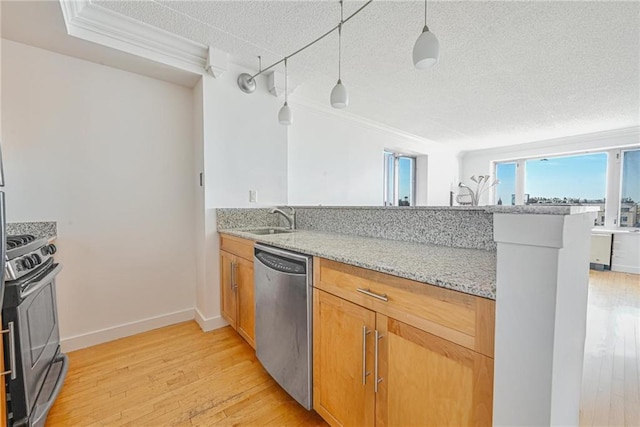 kitchen with light wood-style floors, a sink, a textured ceiling, and stainless steel appliances