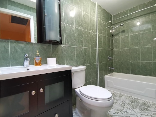 bathroom with tile walls, toilet, vanity, shower / bath combination, and backsplash