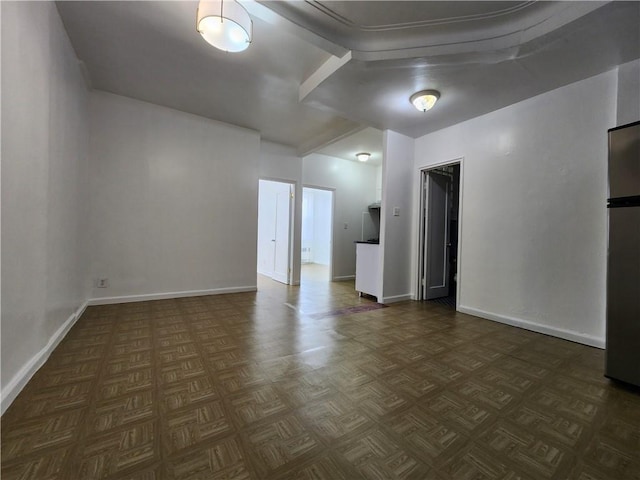 unfurnished room with baseboards