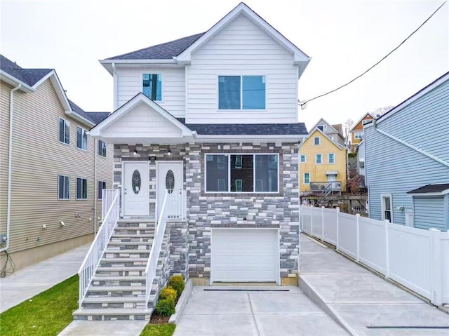 146 Beach St, Staten Island, NY 10304 - view of front of property with stone siding, a garage, driveway, stairs, and a shingled roof
