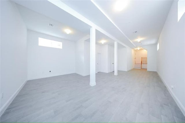 146 Beach St, Staten Island, NY 10304 - below grade area featuring light wood-type flooring, baseboards, and stairway