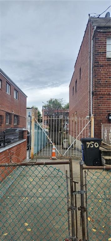 750 Warwick St, Brooklyn, NY 11207 - view of property exterior with brick siding and a gate
