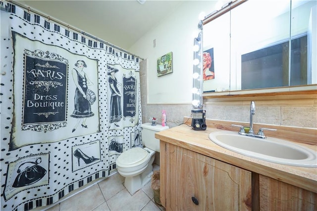 bathroom featuring curtained shower, tile patterned flooring, vanity, and toilet