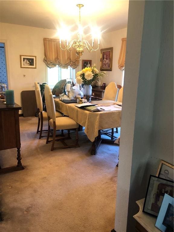 carpeted dining room with a chandelier