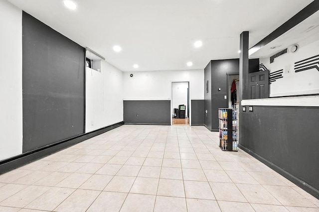 empty room with light tile patterned floors, baseboards, and recessed lighting