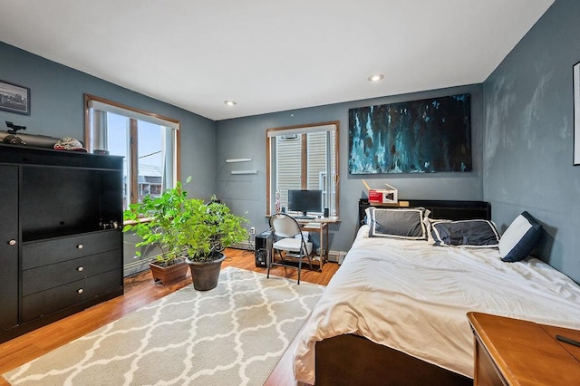 bedroom with wood finished floors and recessed lighting